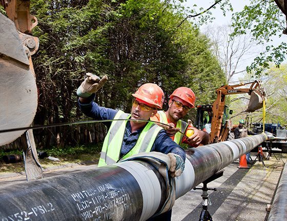 Men installing large gas lines