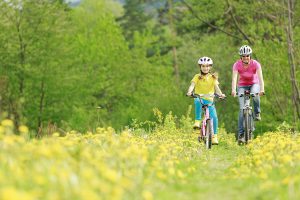 Biking - Bike riding - young girl with mother on bike, active family concept