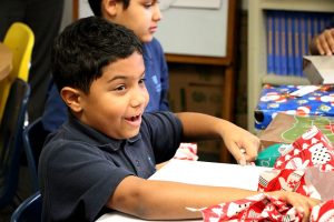 LaSalle - Christmas Project - Fourth Grader Opening His Presents