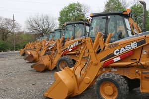 Danella 30th Annual Auction - Line up of backhoes